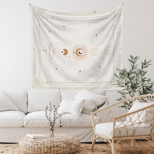 Detail of celestial tapestry featuring sun and moon phases on a boho fabric wall hanging