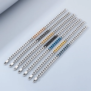 Close-up of multicolored stainless steel Cuban link bracelets in silver, gold and black