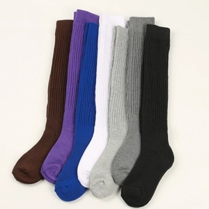 Detailed flat lay of seven multi-colored knitted slouch socks with ribbed texture