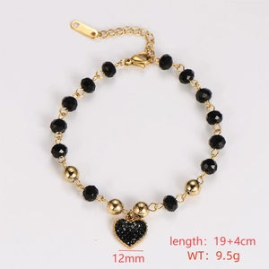 Detailed view of a gold-tone heart charm bracelet with black beads and size labels