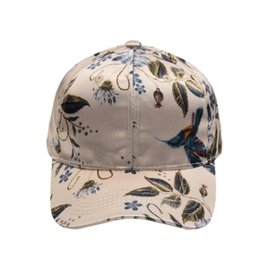 Detailed macro view of the champagne satin fabric with floral and bird print embroidery