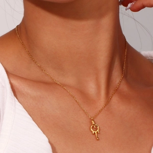 Close-up of a model wearing a gold 18K plated lava key pendant necklace for women