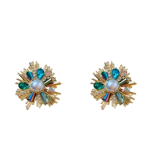 Vintage style gold earrings with white pearl center and blue-green crystal accents