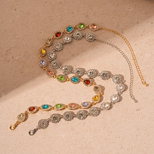 Vintage luxury water-drop diamond pendants in gold and silver finishes on stone background