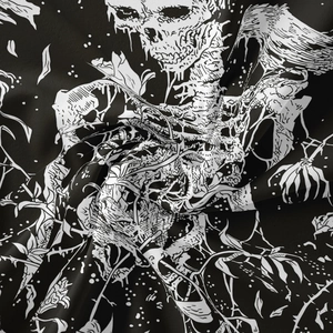 Close-up of bohemian skull tapestry featuring detailed roses and thorns on soft fabric