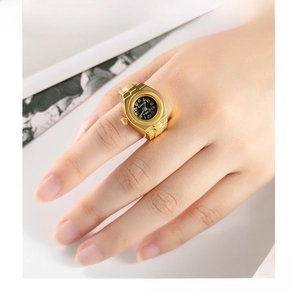 Macro detail of golden vintage rivet heart watch ring with a black quartz dial on hand