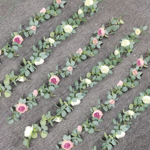 Artificial eucalyptus garland with pink roses and silk peonies for wedding wall decoration