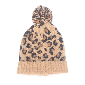 Close-up of leopard print knit beanie with a fluffy pompom and ribbed cuff detail