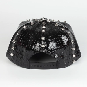 Rear view of punk snapback cap showing black crocodile leather texture and silver studs