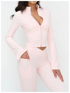 Detail of light pink slim-fit yoga jacket with stand collar and cross high waist leggings