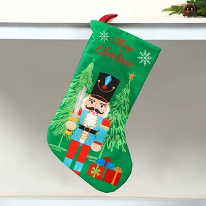 Close-up of green Christmas stocking with Nutcracker soldiers and Merry Christmas text