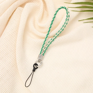 Detail of green and cream woven phone wrist strap with silver metal connectors