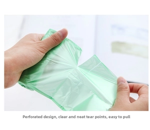Close-up of green household trash bag showing strong material and perforated tear line