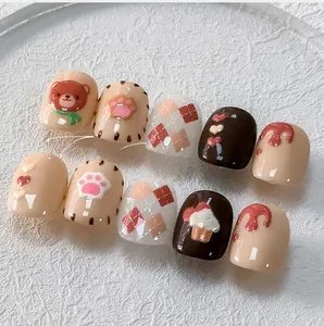 Detailed view of 5D nail art stickers featuring brown bears, cat paws, and plaid patterns
