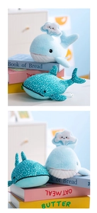 Detailed view of soft whale plushies with cloud applique and cute polka dot patterns
