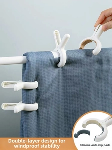 Detail of white plastic clothes peg with grey non-slip silicone pad on drying rack