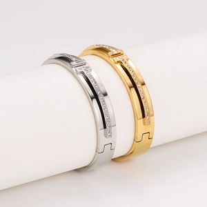 Polished stainless steel H-clasp bangle with sparkling pavé crystals in gold and silver