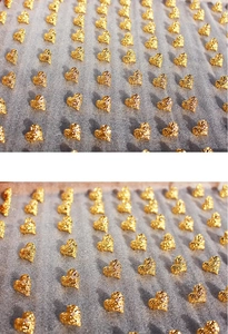 Macro shot of gold heart earrings with unique lava texture on a display board