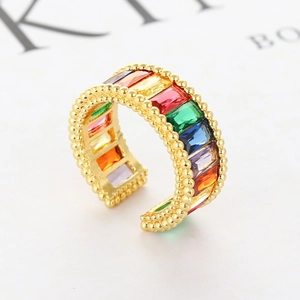 Macro view of gold rainbow zircon ring featuring beaded edges and colorful stones