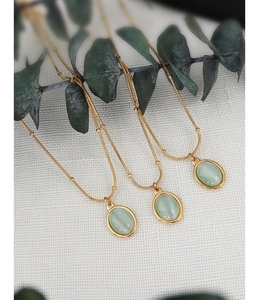 Three 18k gold plated stainless steel necklaces with green cat-eye stone pendants