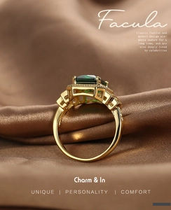 Close-up of emerald-cut green zircon ring with gold plated filigree and pave set stones