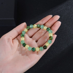 Elastic beaded bracelet featuring green turquoise, aventurine, and golden crackle quartz