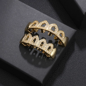 Golden hip hop grillz set with sparkling white zircon stones in a black gift box
