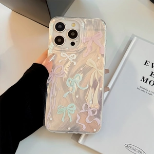 Detail of clear iPhone case with pearlescent swirl texture and colorful 3D bows