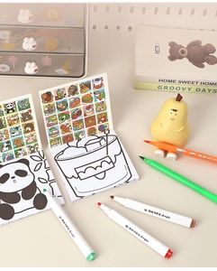 Mini cartoon coloring book for kids with acrylic markers on a cozy creative desktop