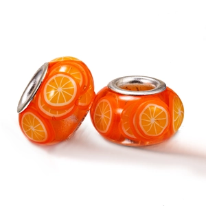 DIY jewelry kit featuring orange fruit slice beads with silver cores on white background