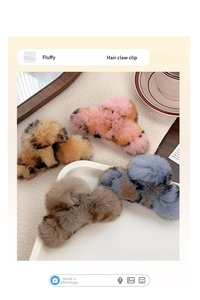 Detail of four fluffy faux fur hair claw clips in leopard and solid colors for winter