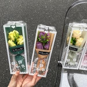 Artificial soap rose bouquets in transparent gift boxes with decorative black ribbons