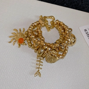 Multi-layer gold metal beaded bracelet with sun and shell charms in vintage style