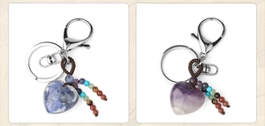 Detail of heart-shaped natural stone keychains with amethyst and sodalite textures