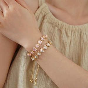 Close-up of heart-shaped zircon bracelets with adjustable drawstring and gold plating