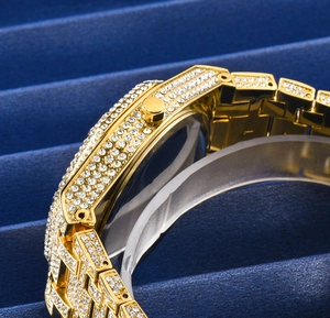 Macro side view of luxury gold watch with full diamond setting and octagonal bezel