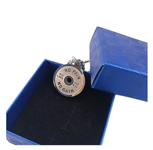 Detailed shot of silver barbell necklace with No Pain No Gain engraving in a blue gift box