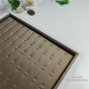 Detailed top view of a 100-slot metallic jewelry display tray for rings and earrings