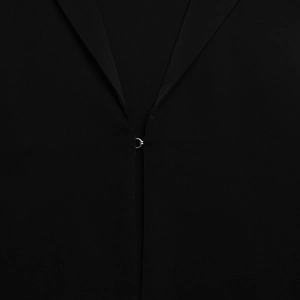 Macro shot of delicate metal buttons and fine knit texture on a black summer cardigan