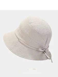 Detail view of beige textured fisherman hat with bow ornament and color options