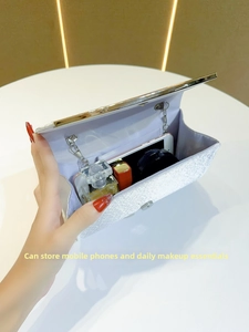 Interior detail of silver sequin evening clutch showing space for phone and cosmetics
