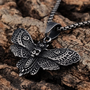 Pendentif papillon crâne gothique en argent vintage sur fond d'écorce naturelle brute