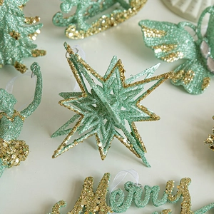 Mint green Christmas ornaments with gold glitter including star and butterfly designs