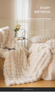 Close-up of soft faux fur blanket with premium vertical textured stripes in cream white
