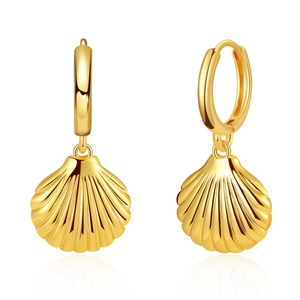 Detailed view of polished gold shell earrings with elegant ribbed texture on white background