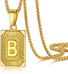 Detail of gold rectangular pendant with letter B and box chain necklace for men and women