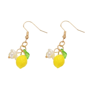 Detail of yellow lemon dangle earrings with green leaves and white pearl flowers