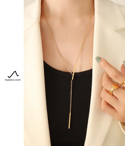 Macro detail of 18K gold-plated stainless steel Y-shaped long bar pendant necklace for women