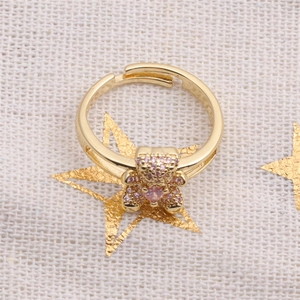 Detail of gold-plated bear ring with pink zircon pavé and adjustable open band
