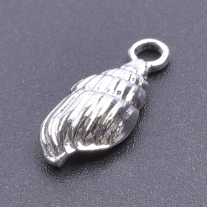 Detailed view of a silver stainless steel seashell pendant on a textured dark background